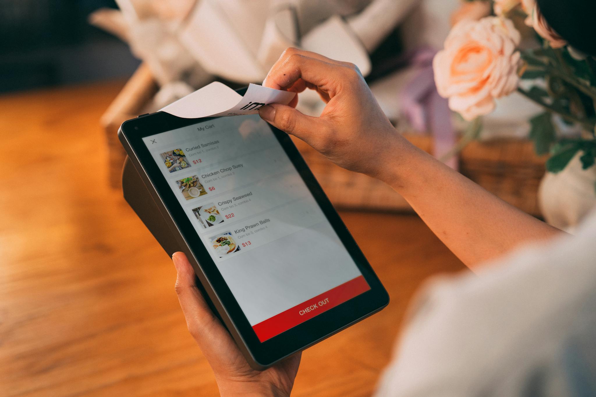 Hands using tablet for cashless payment, showcasing modern technology in retail.